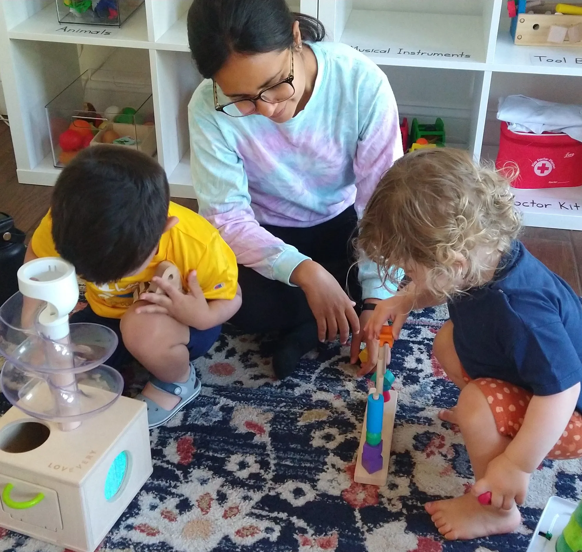 Nora Mami engaging with children through play-based learning activities
